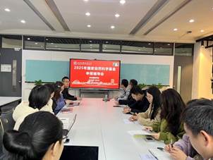 A group of people sitting at a table
Description automatically generated